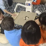 Children learning and playing Weiqi together during Hong Meng Members' Day at Hong Meng Academy in Singapore