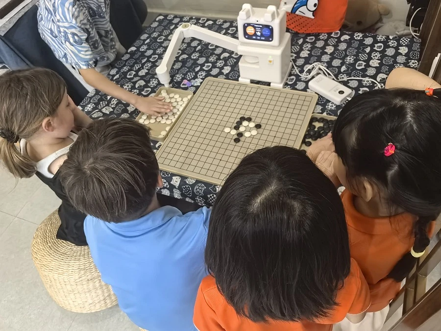 Children learning and playing Weiqi together during Hong Meng Members' Day at Hong Meng Academy in Singapore