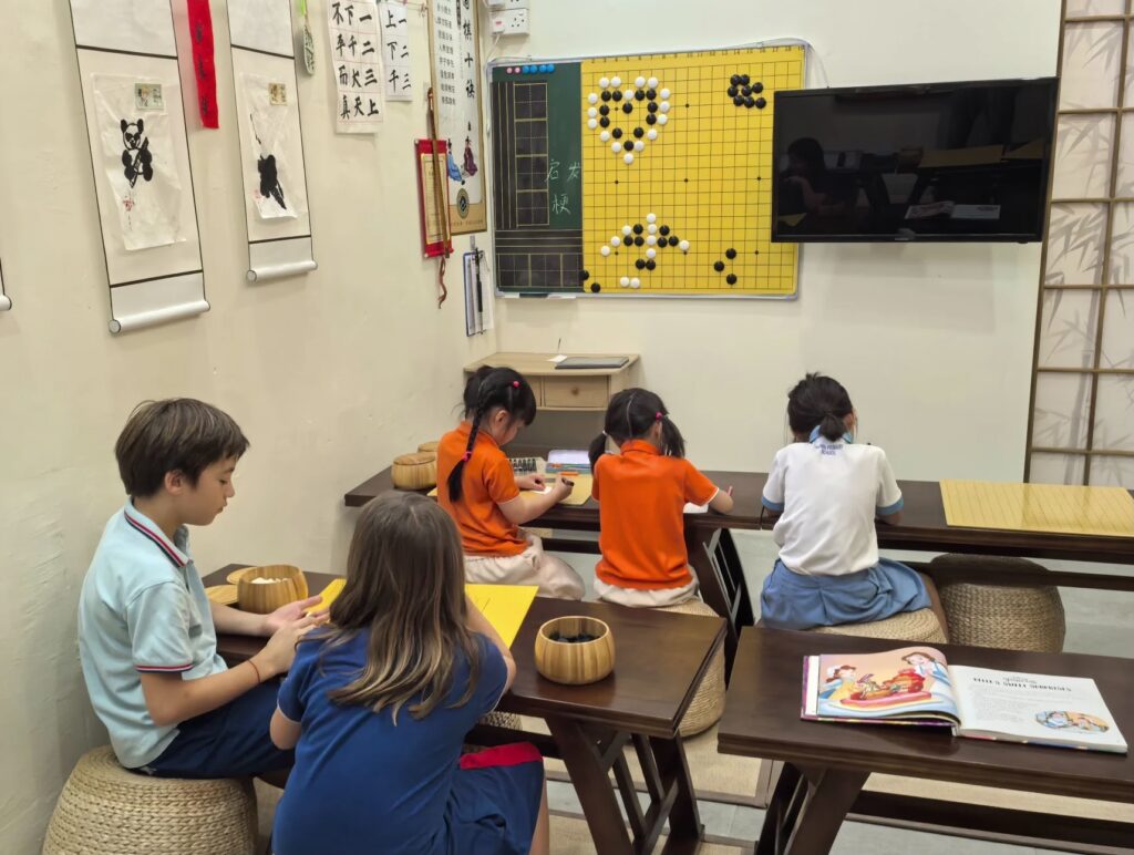 Student Care Children learning calligraphy and Weiqi at Hong Meng Academy in Hougang