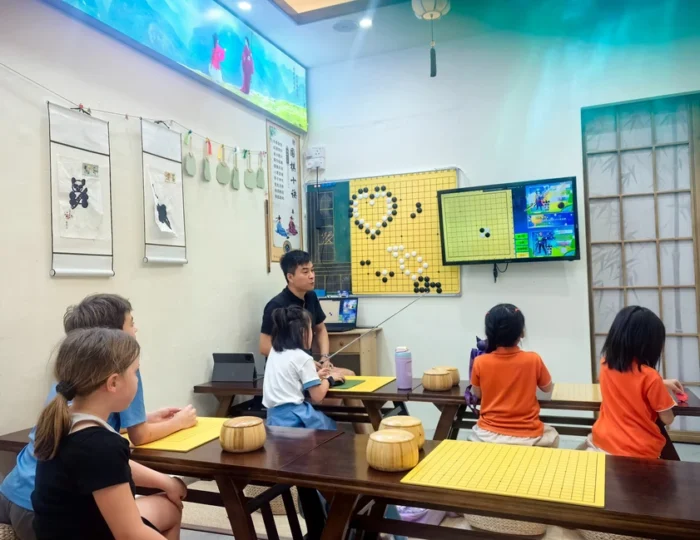 Children attending a Weiqi (Go) group lesson at Hong Meng Academy in Hougang, Singapore.